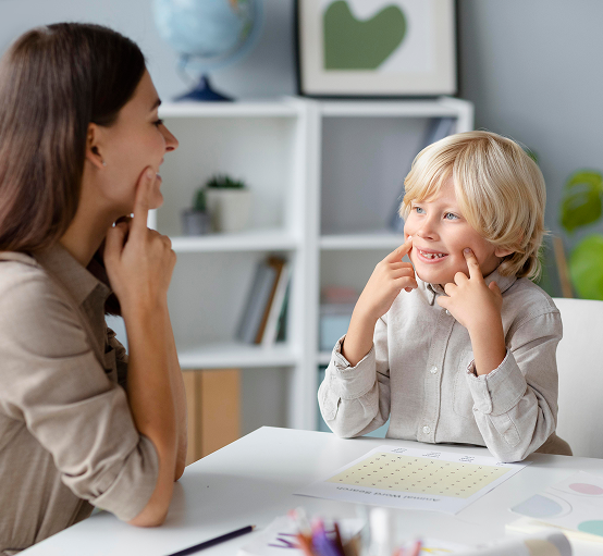 woman-doing-speech-therapy-with-little-blonde-boy